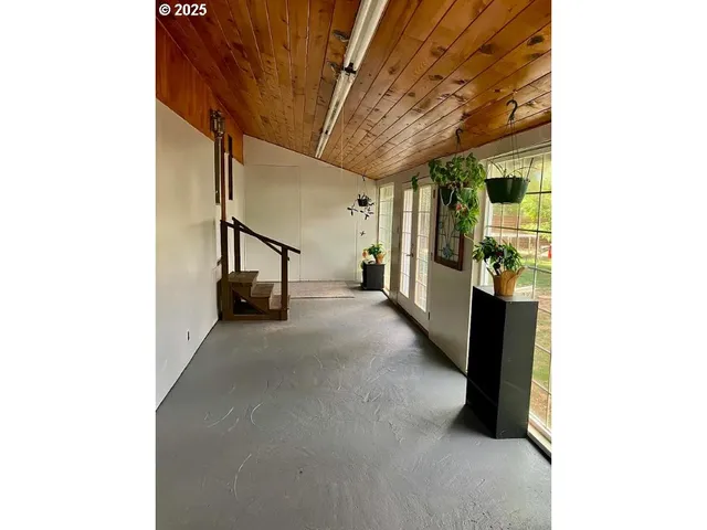 a view of a hallway with seating space