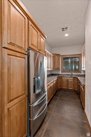 2464 East Granite Way St. George, UT 84790 - Photo 56 of 106 Butler's Kitchen featuring concrete flooring, stainless steel fridge, dark stone countertops, and recessed lighting