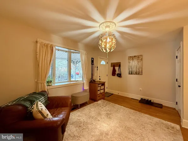 a living room with furniture and a chandelier