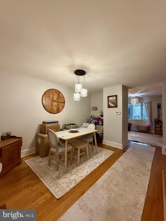 a view of a livingroom and a dining room with wooden floor
