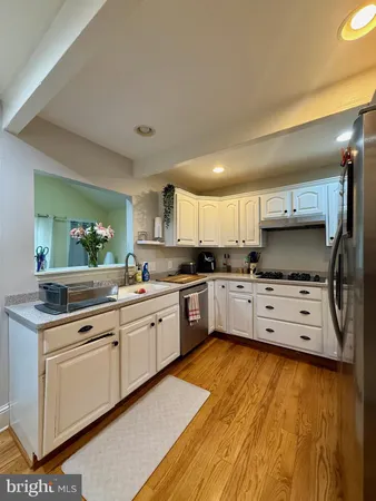 a kitchen with stainless steel appliances kitchen island granite countertop a stove and a sink