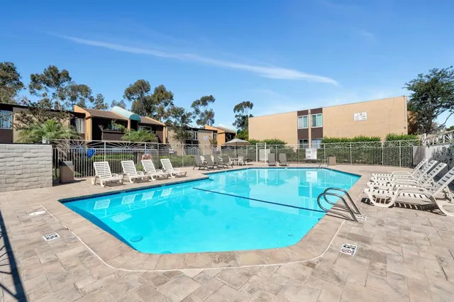 a view of a swimming pool with outdoor seating