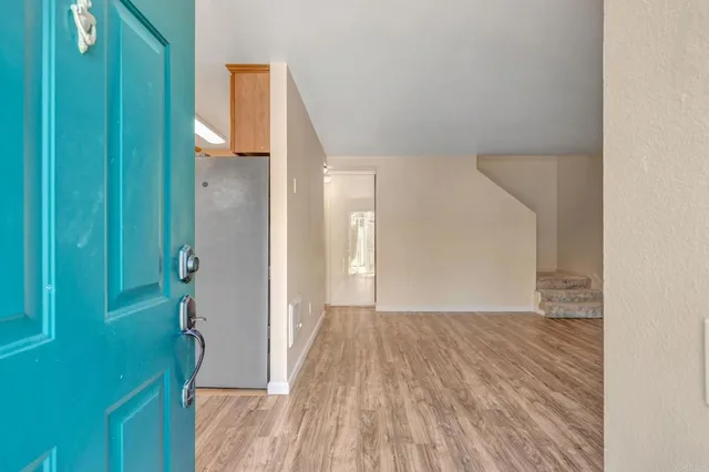 a view of hallway with wooden floor