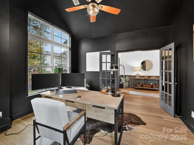 a dining room with furniture a chandelier and wooden floor