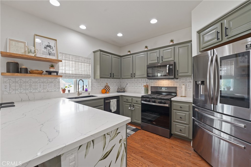 a kitchen with kitchen island a sink stove and refrigerator