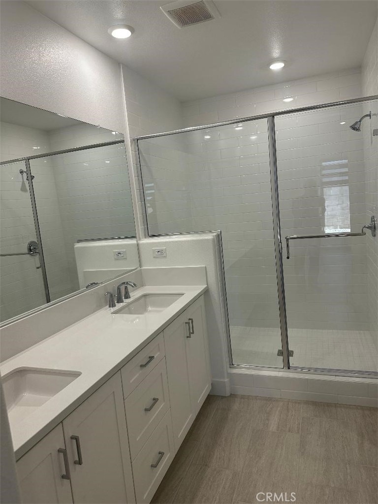 512 Nielson Irvine, CA 92618 - Photo 12 of 14 a bathroom with a double vanity sink and mirror