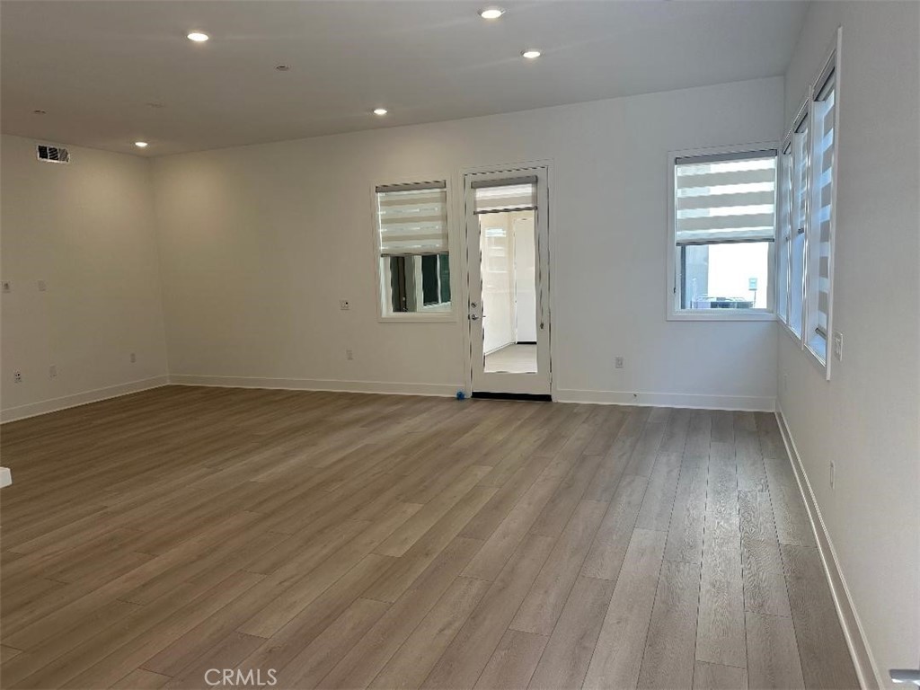 512 Nielson Irvine, CA 92618 - Photo 2 of 14 an empty room with wooden floor and windows