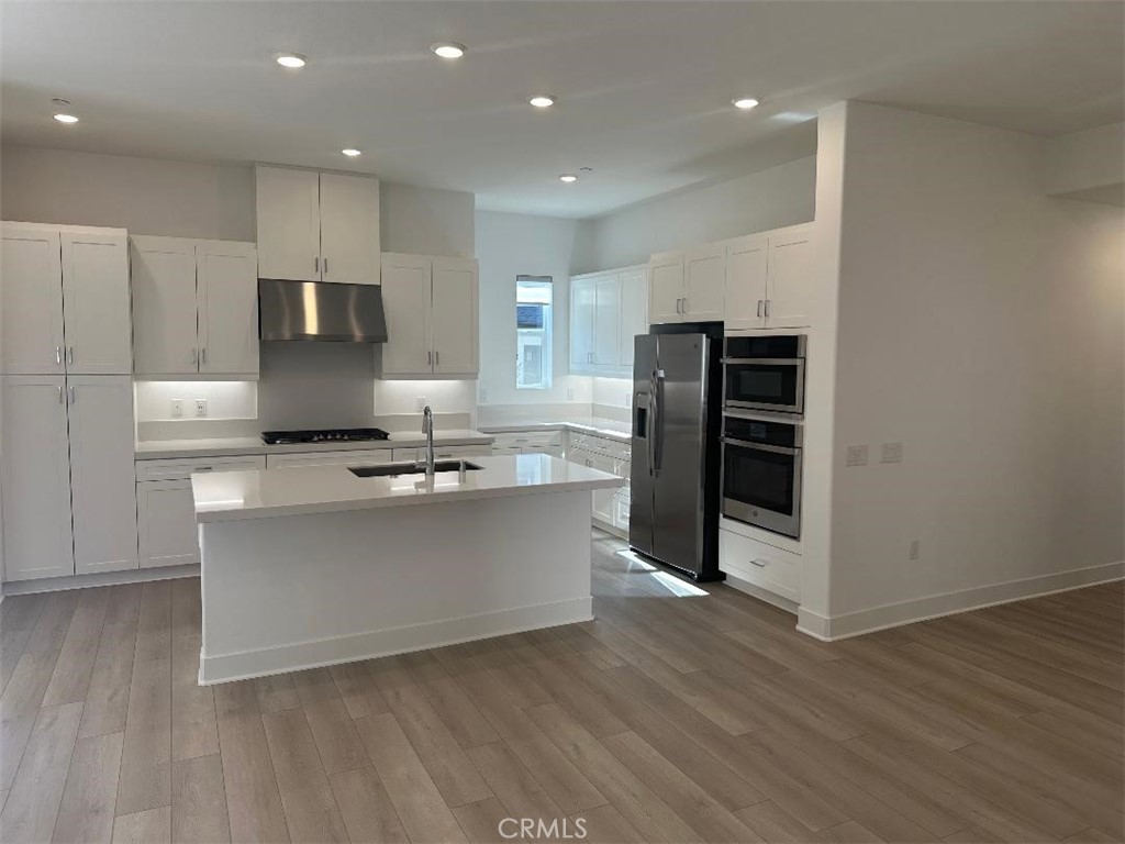 512 Nielson Irvine, CA 92618 - Photo 3 of 14 a kitchen with stainless steel appliances a refrigerator and a stove top oven