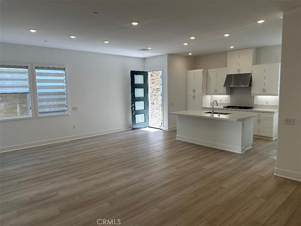 512 Nielson Irvine, CA 92618 - Photo 5 of 14 a large kitchen with stainless steel appliances granite countertop a large counter top and a wooden floor