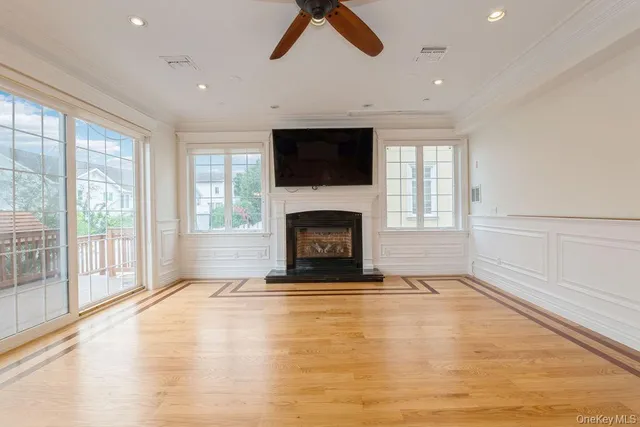 a view of an empty room with kitchen appliances and a large window