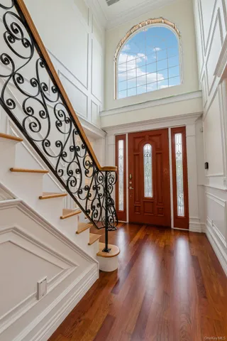 a view of empty room with wooden floor and fireplace