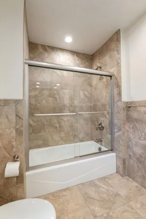 a bathroom with a double vanity sink a toilet and a shower