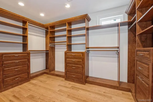 a view of empty room with wooden floor and ceiling fan