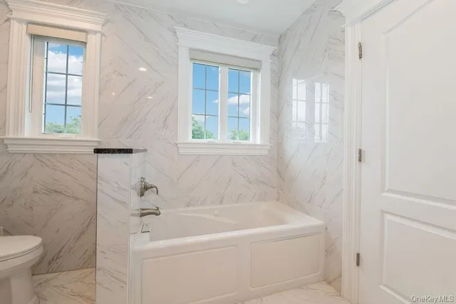 a bathroom with a bathtub and a shower