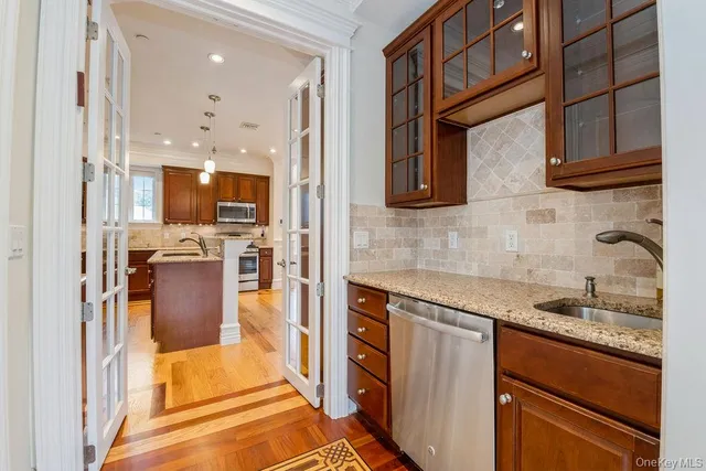 a kitchen with stainless steel appliances granite countertop a refrigerator and a sink