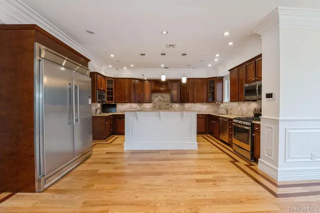 a kitchen with sink cabinets and a wooden floor