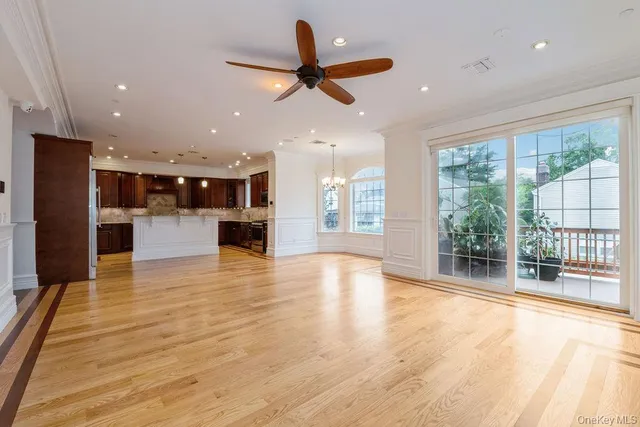 a view of empty room with wooden floor and fireplace