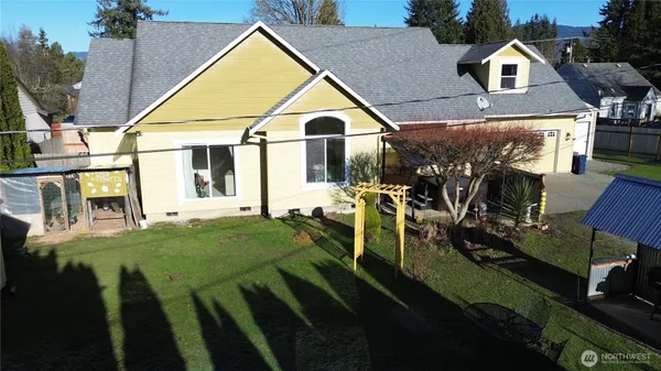 a view of backyard of house and car parked