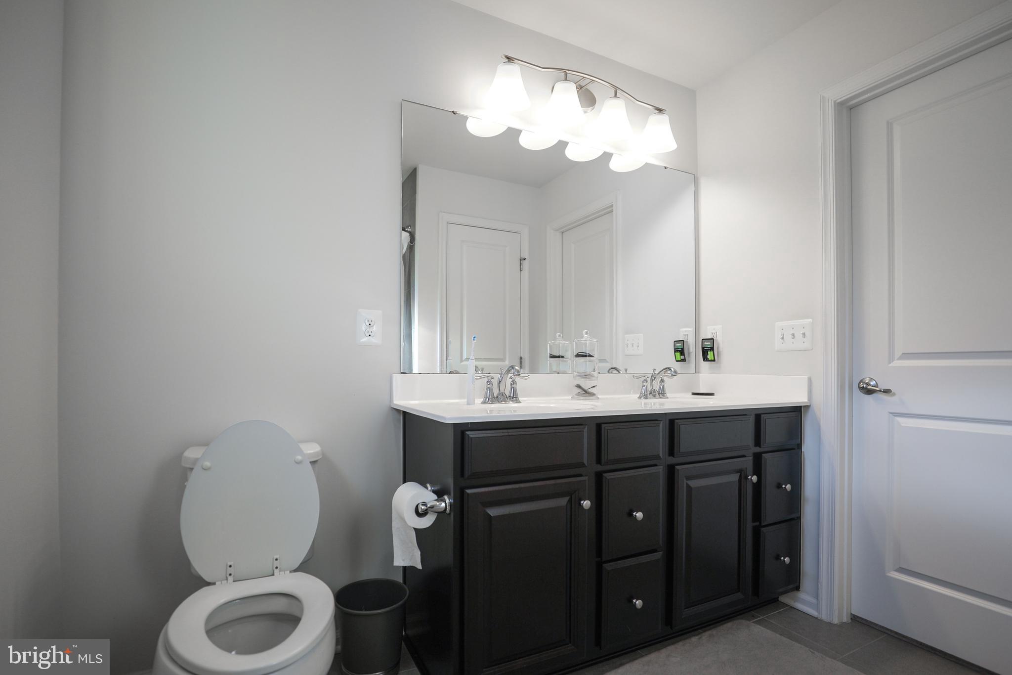 1024 Cook Drive Southeast Washington, DC 20032 - Photo 20 of 44 a bathroom with a toilet sink and mirror