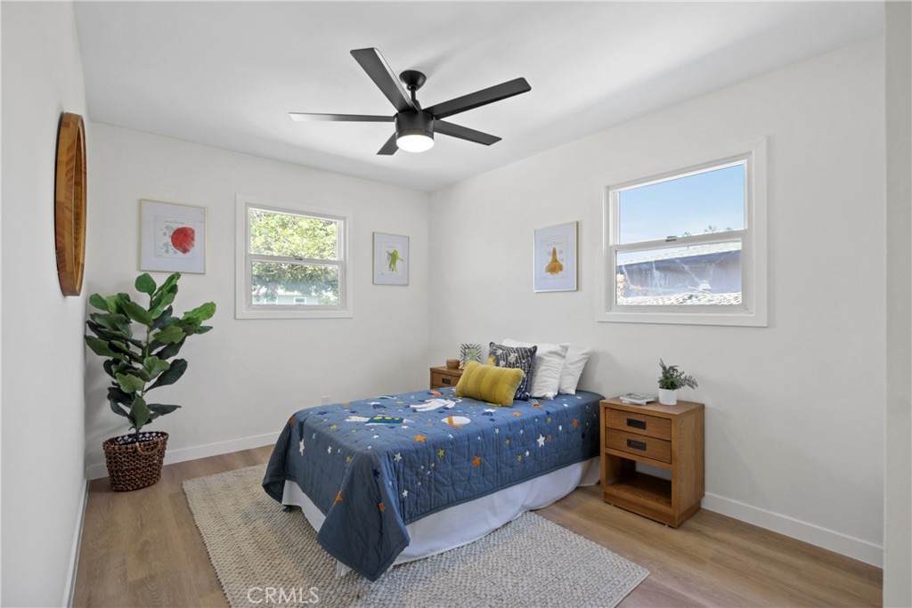 12262 Morrie Lane Garden Grove, CA 92840 - Photo 13 of 16 a bedroom with a bed a window and a potted plant