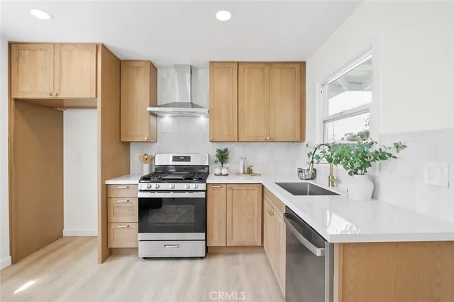 a kitchen with a sink stove and cabinets