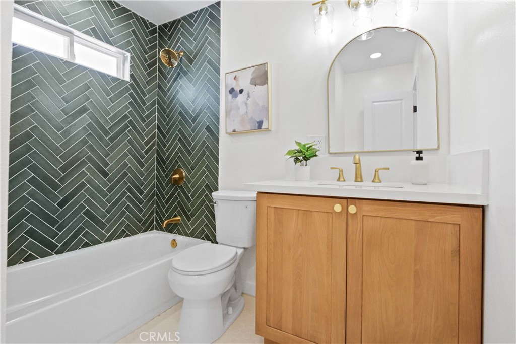 12262 Morrie Lane Garden Grove, CA 92840 - Photo 8 of 16 a bathroom with a granite countertop sink toilet and shower