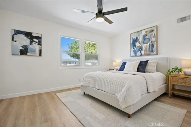 a bedroom with a large bed and a window