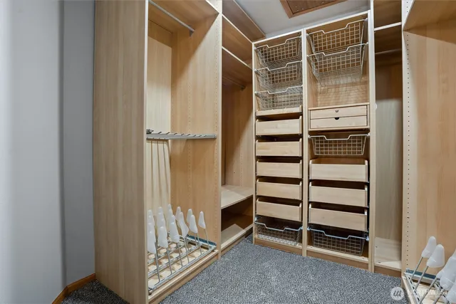 a view of walk in closet with empty racks