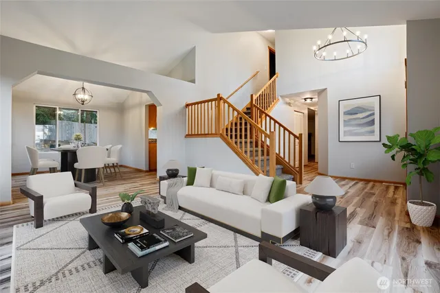 a living room with furniture a rug and a potted plant