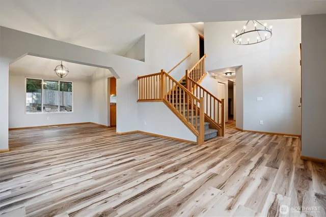 a view of a room with wooden floor and stairs