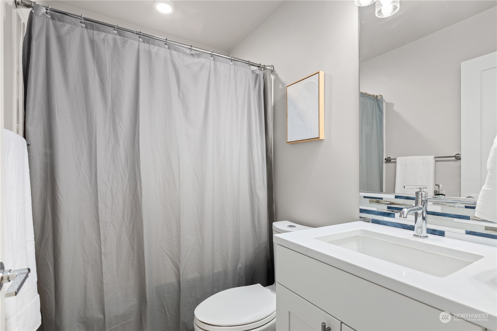22803 23rd Avenue Southeast Bothell, WA 98021 - Photo 34 of 40 a bathroom with a sink a toilet and shower curtain