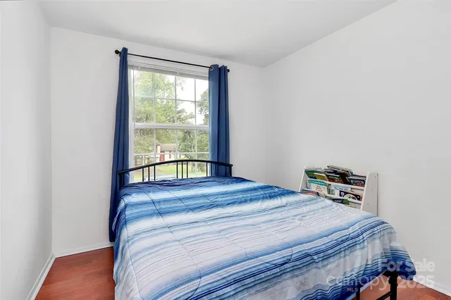 a bed sitting in a bedroom next to a window