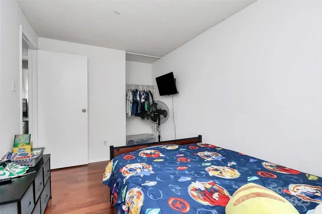 a bedroom with a bed and a tv in it