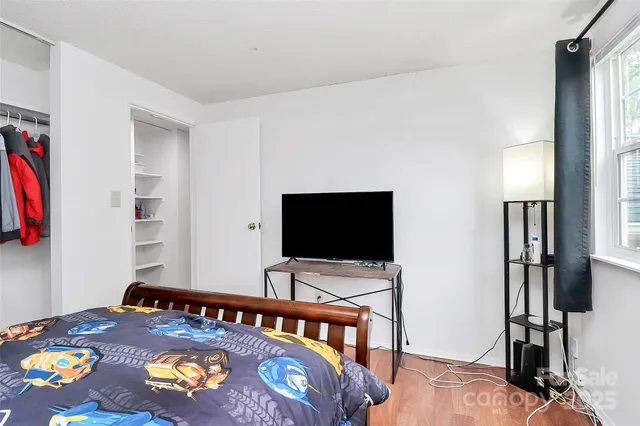 a bedroom with a bed and flat screen tv