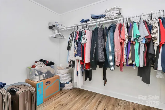 a view of walk in closet with clothes