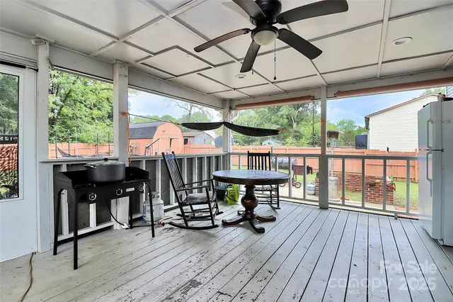 a view of a patio with a table chairs and wooden floor