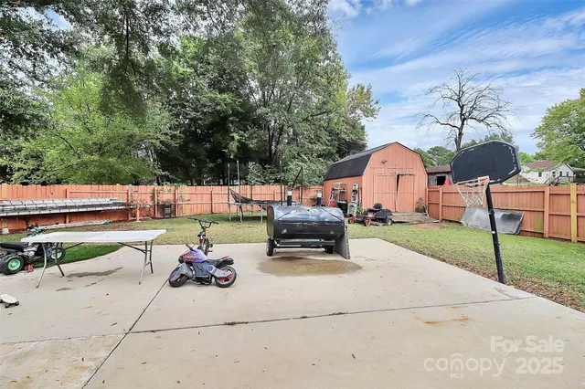 a backyard of a house with barbeque oven table and chairs
