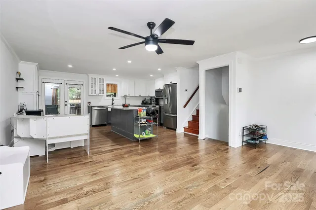 a living room with furniture and kitchen view