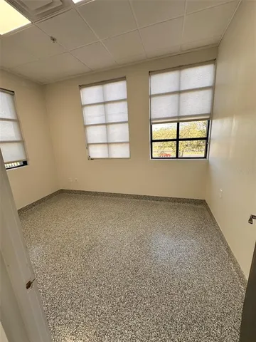 an empty room with windows and closet