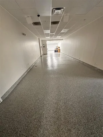 an empty room with windows and entrance