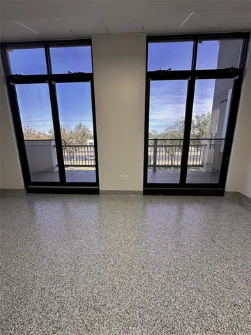 a view of an empty room with windows