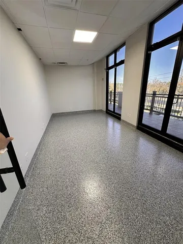 a hallway with painting on wall and a potted plant