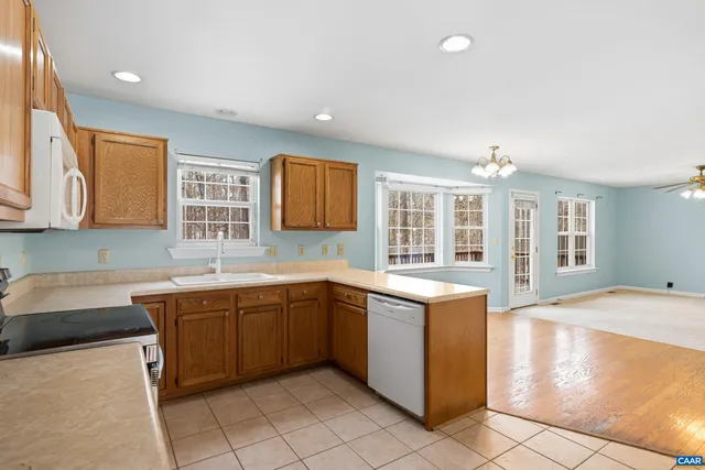 a bathroom with a sink a toilet and a window