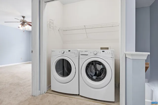 a view of an empty room with a ceiling fan