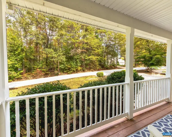 a view of a balcony with wooden floor