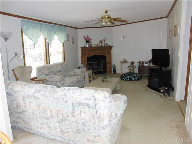 1224 Roffler Street Garner, NC 27529 - Photo 14 of 14 Open floor plan! This large family room area is open to the kitchen and offers a fireplace and ceiling fan.