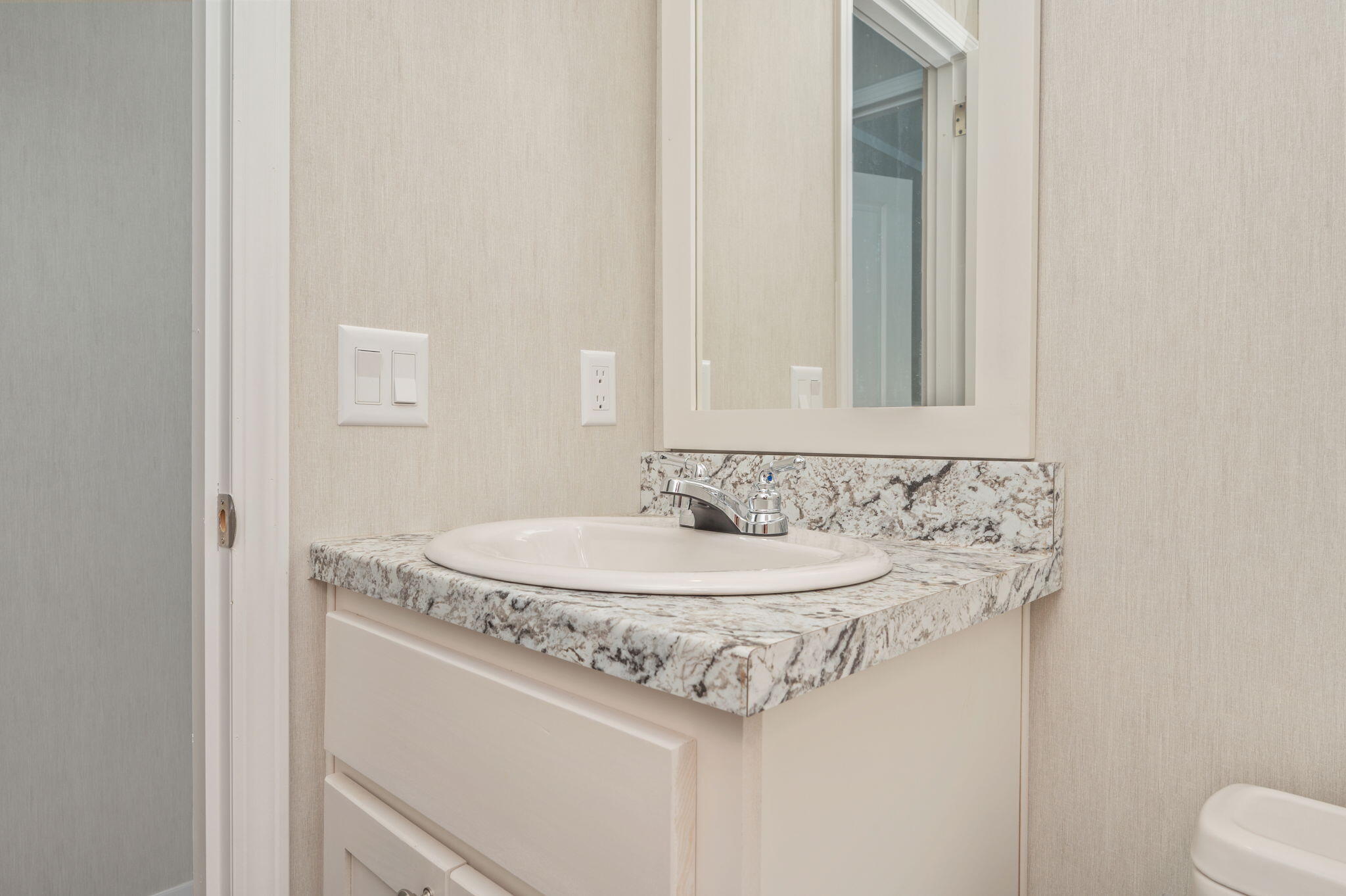 126 Pansy Lane DeFuniak Springs, FL 32433 - Photo 26 of 32 a bathroom with a sink and a mirror