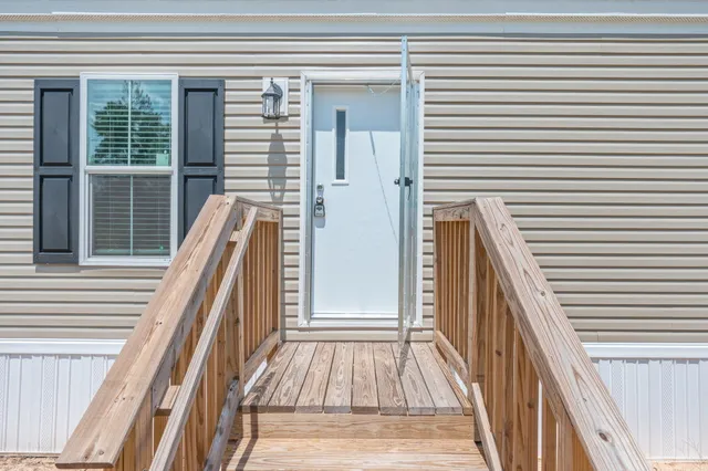 a view of a balcony with wooden floor and stairs