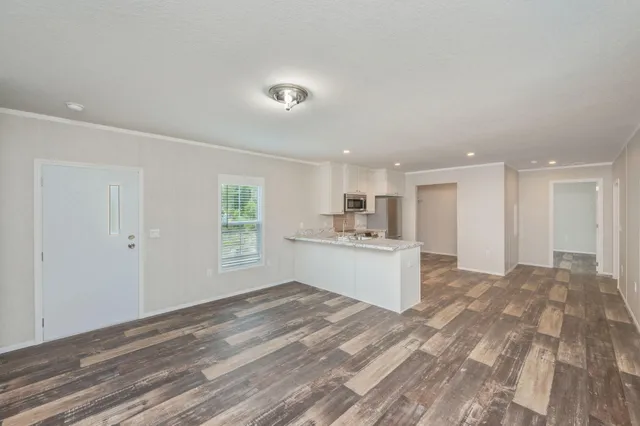 a kitchen with a refrigerator sink and a large window