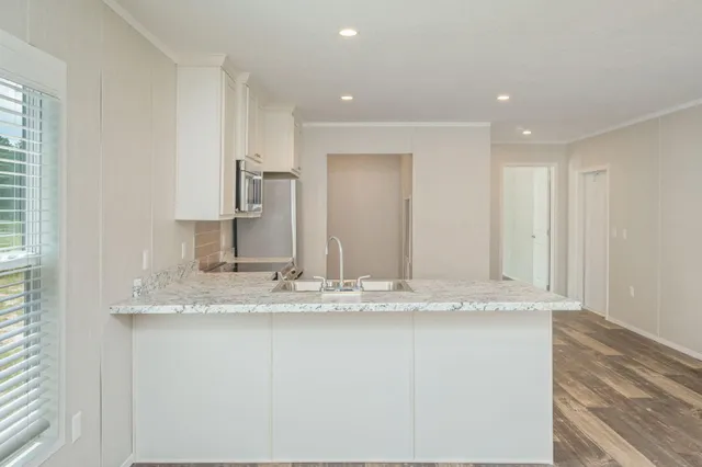 a view of bathroom with granite countertop sink